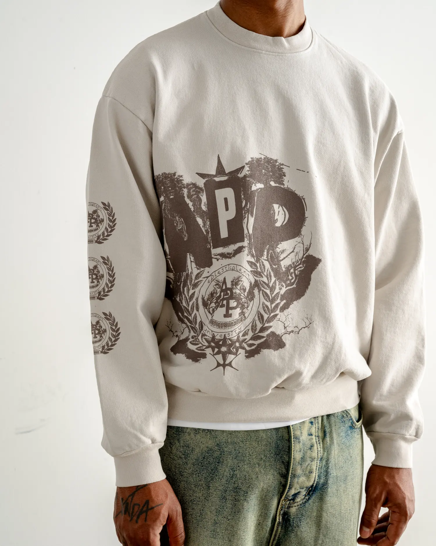 The crest crewneck worn front on, seal at the chest