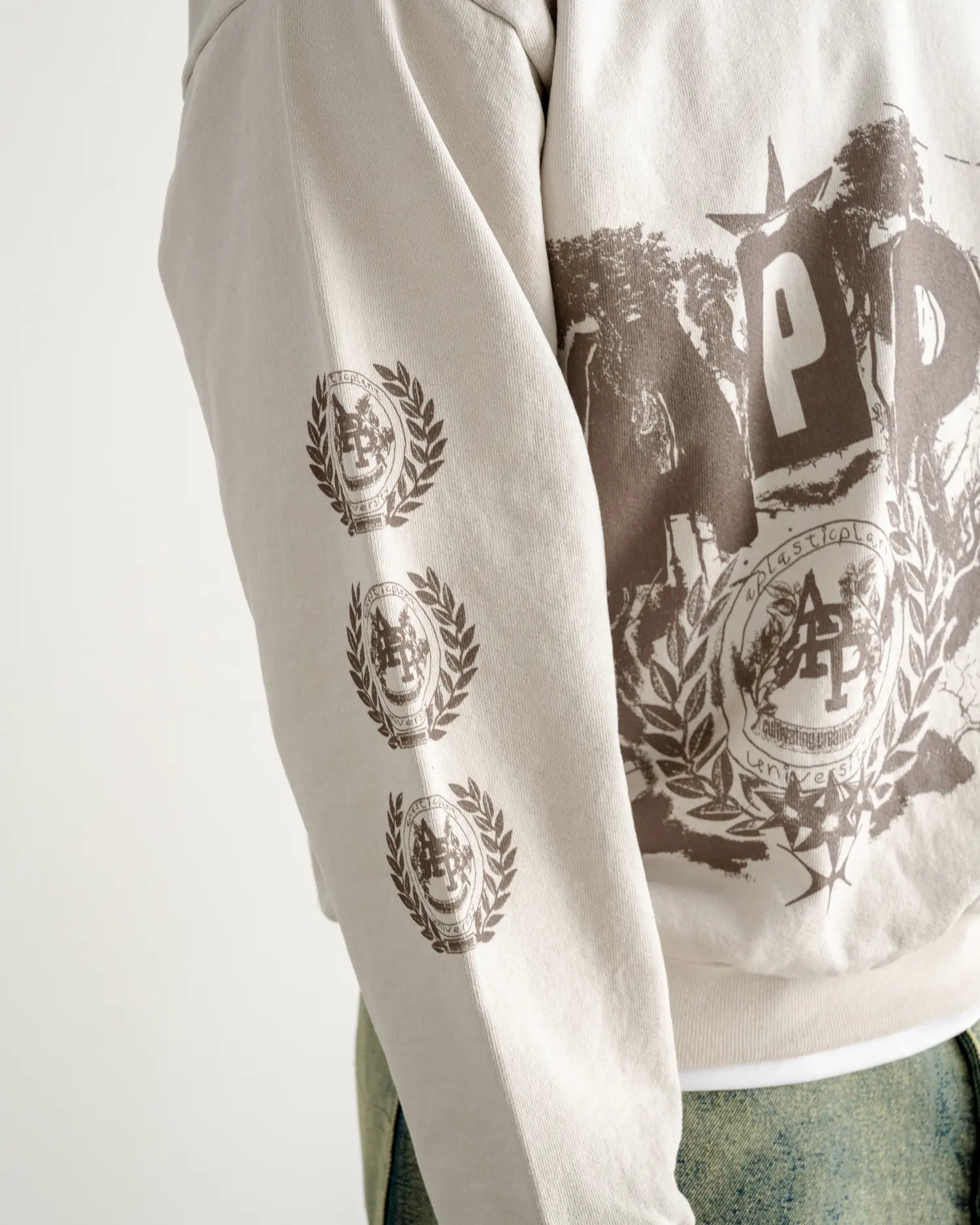 Sleeve detail — the seal repeated down the arm beside the chest print