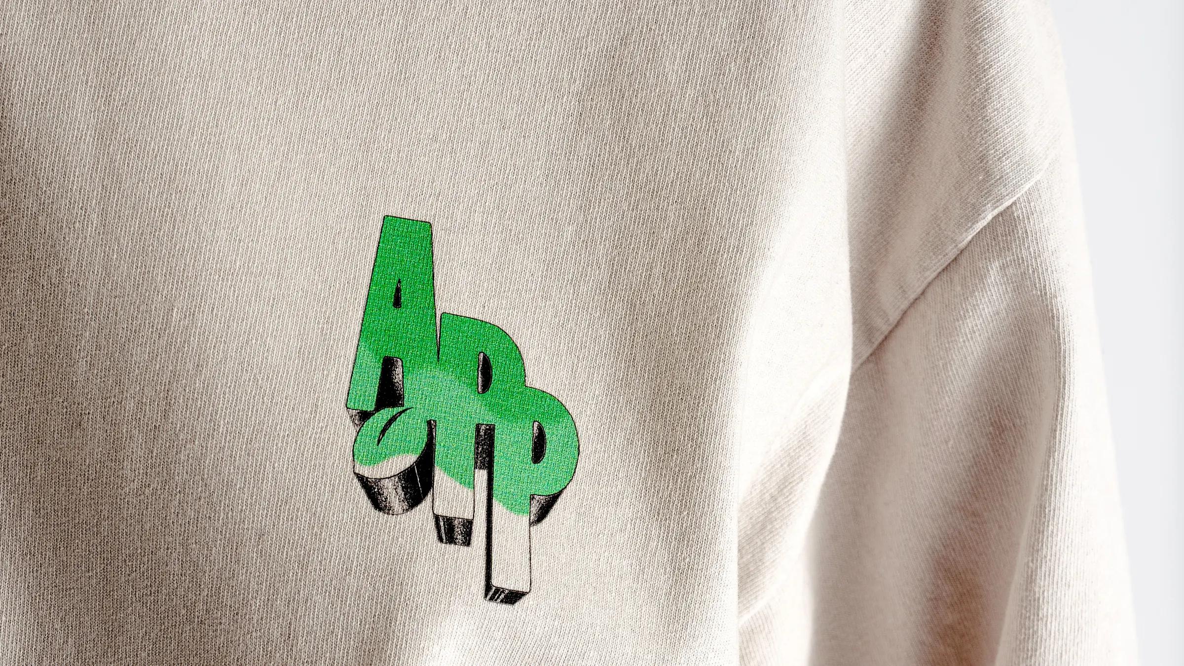The green monogram printed at the chest, close in on the fabric