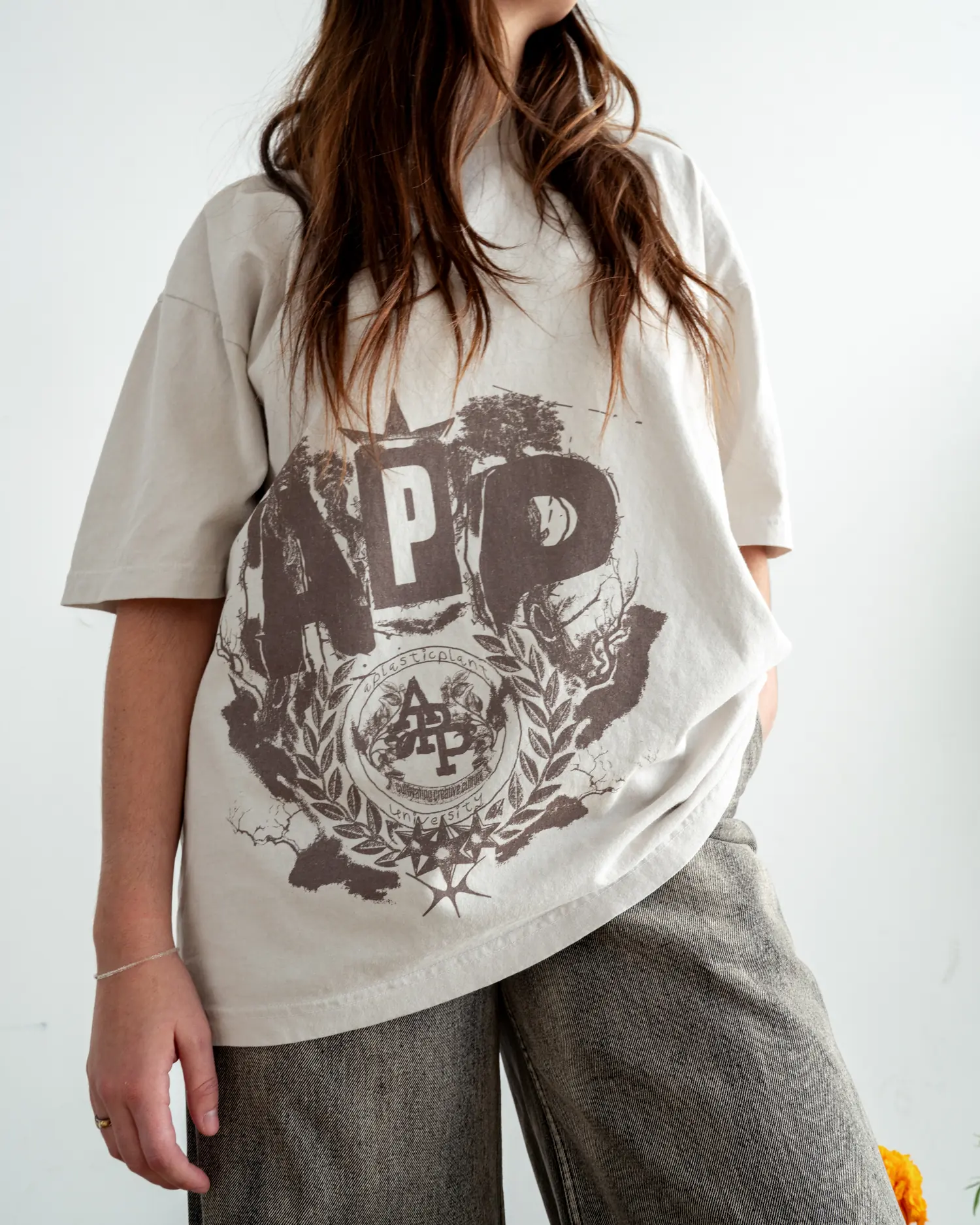 The crest tee worn oversized, seal at the chest