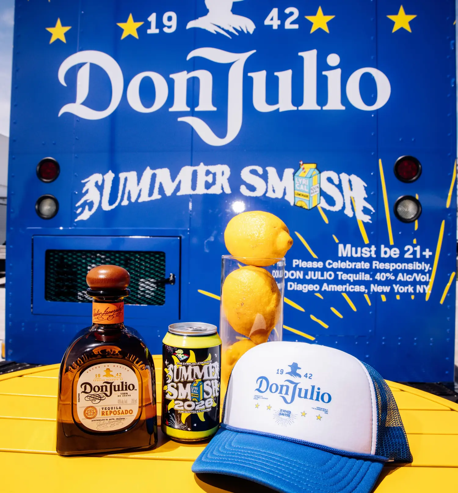 Bottle, co-branded can and cap on the yellow table